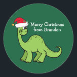Cute Christmas Dinosaur in Santa Hat Custom Kids Classic Round Sticker<br><div class="desc">Awesome green dinosaur smiling and looking very cute in a holiday red Santa hat. Kids will love this cool green holiday party favor label. Customize these Christmas gift sticker with your own text in white.</div>