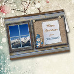 Cute Colorado Bulletin Board Christmas Card<br><div class="desc">This cute Christmas card from Colorado features a bulletin board with your message, and an image of a little snowman carrying his skis. Beside the bulletin board is a window showing beautiful snow covered , majestic mountains against a bright blue sky. The text on the front can be changed to...</div>