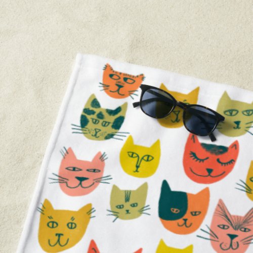 Cute colorful cats on white beach towel