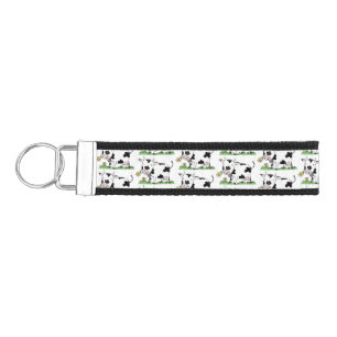 Cute cow in green field cartoon illustration wrist keychain
