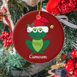 Cute Custom Christmas Frog Santa Ceramic Ornament<br><div class="desc">Christmas frog in cute red Santa Claus hat with jingle bells and mistletoe on a cool red holiday ornament. This pretty holiday animal gift featuring a smiling green froggie animal makes me happy and full of Christmas cheer. Personalize with a kids name for a fun gift.</div>