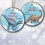 Cute Dinosaur Dino-Mite Kid's Christmas Ceramic Ornament<br><div class="desc">On the front of this Christmas ornament is an adorable blue dinosaur. The red and blue custom text says "Merry Christmas" and your child's name. The back of the ornament has another dinosaur image, and the text currently says "You are DYNO-MITE" and "Love, Mom and Dad". It's easy to change...</div>