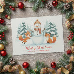 Cute Foxes and Snowman Merry Christmas Holiday Card<br><div class="desc">Celebrate the magic of winter with this adorable watercolor Christmas card featuring two playful foxes and a cheerful snowman in a snowy forest of evergreen trees. The charming boho watercolor style captures cozy woodland warmth and joyful holiday spirit. Personalize the front with your own “Merry Christmas” greeting and sender name...</div>