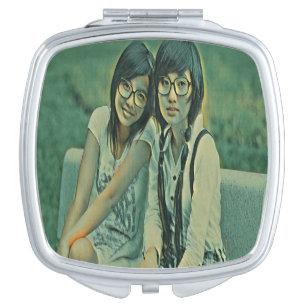 Cute friends sitting next to each other compact mirror