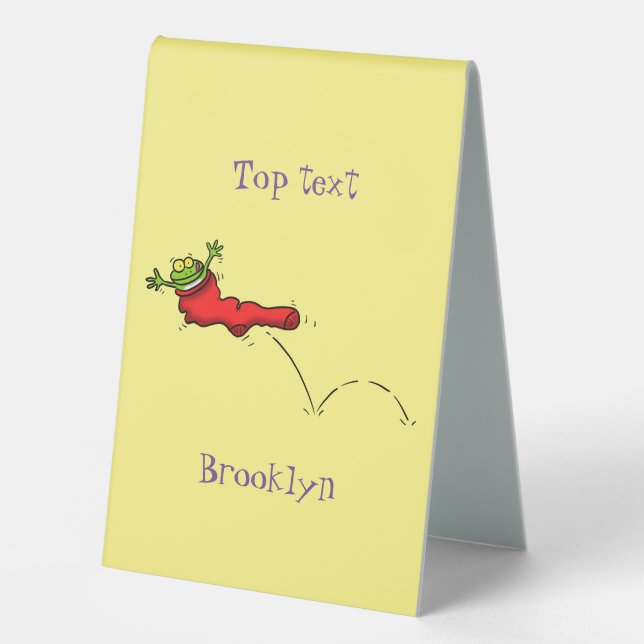 Cute frog in a red sock jumping cartoon table tent (Front)