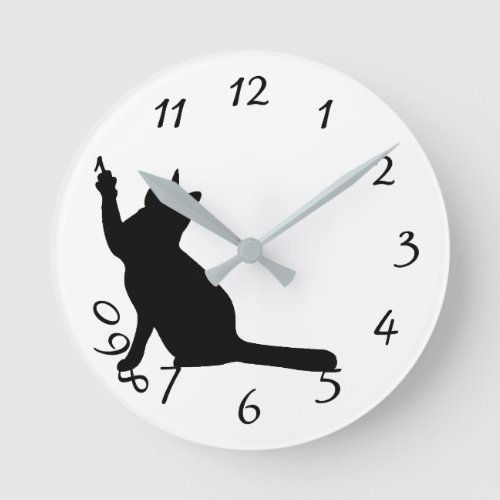 Cute funny black cat playing with numbers clock