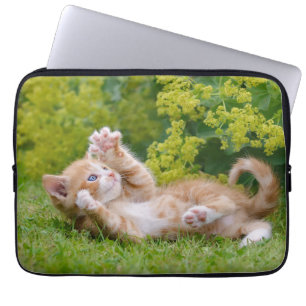 Cute funny cat kitten playing in a flowery garden laptop sleeve