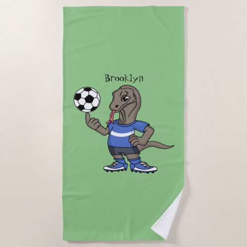 Cute funny Komodo dragon playing soccer cartoon Beach Towel