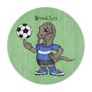 Cute funny Komodo dragon playing soccer cartoon Cutting Board