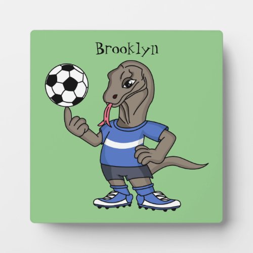 Cute funny Komodo dragon playing soccer cartoon Plaque