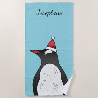 Cute Gentoo Penguin Wearing A Santa Hat On Blue Beach Towel