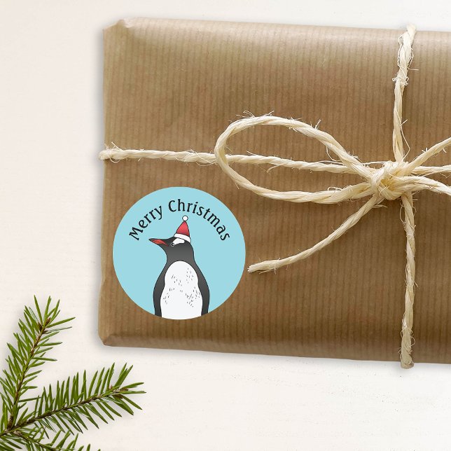 Cute Gentoo Penguin Wearing A Santa Hat On Blue Classic Round Sticker (Festive design for the Holiday season. Feel free to personalize with your custom text.)