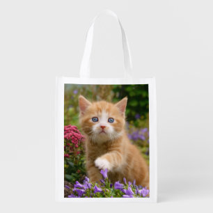Cute ginger kitten in a garden grocery bag