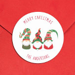 Cute Gnomes Merry Christmas Classic Round Sticker<br><div class="desc">Simple and cute nordic-style holiday sticker featuring three cute Scandinavian Christmas gnomes with seasonal red and green hats and tunics. You can personalize a "Happy Holidays,  "Merry Christmas, " etc.,  greeting and your name in fun typography.</div>