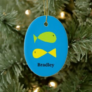 Cute green and yellow fishes on blue ceramic ornament