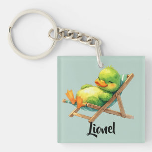 Cute green duck relaxing in a lounge chair keychain