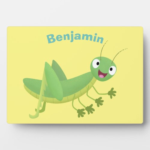 Cute green happy grasshopper cartoon plaque