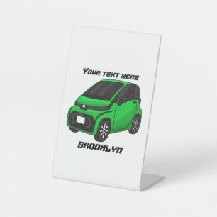 Cute green micro sized car pedestal sign