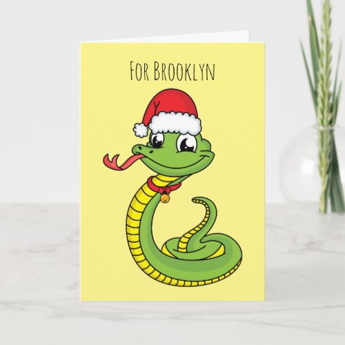 Cute green snake with santa hat cartoon card