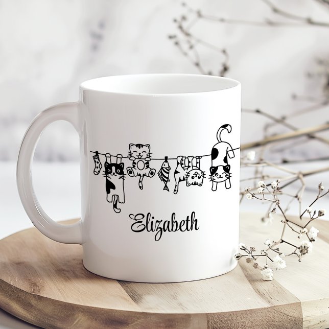 Cute Hanging Kittens Custom Name Coffee Mug (Cute Hanging Kittens Custom Name Coffee Mug on a sunny boho kitchen table with tiny dried flowers)