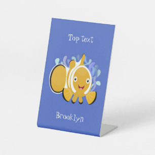 Cute happy clownfish anenome cartoon pedestal sign