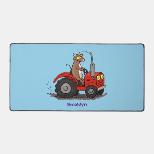 Cute happy cow driving a red tractor cartoon desk mat