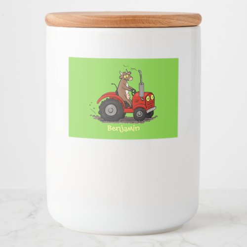 Cute happy cow driving a red tractor cartoon food label