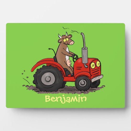 Cute happy cow driving a red tractor cartoon plaque