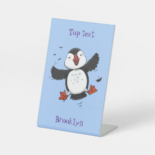 Cute happy flying puffin blue cartoon illustration pedestal sign