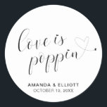 Cute Heart Popcorn Favors Modern Wedding Classic Round Sticker<br><div class="desc">Typography wedding favor stickers featuring the message, "Love Is Poppin" in black calligraphy with a heart dotting the "i's" and a swash at the end and your names and date below, over a white background. The simple and minimal layout and lots of open space give this design a modern feel...</div>