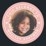 Cute Hearts Circle Frame Photo Name School Coral Classic Round Sticker<br><div class="desc">These adorable,  modern styled stickers feature your kiddo's photo at the center,  with a pastel coral circle frame! Text templates are included for easy personalization. Great for labeling Back to School supplies,  books,  and more! Two little white hearts add an extra cute touch.</div>