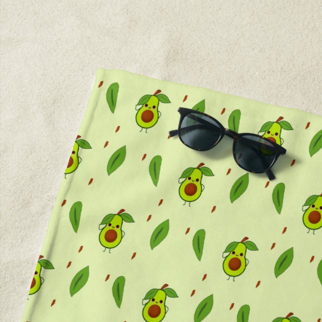 Cute kawaii avocado on green beach towel (In Situ)