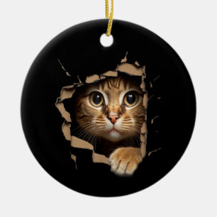 Cute kitten looks from torn fabric Cats Ceramic Ornament