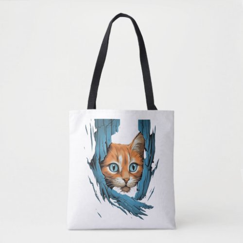 Cute kitten looks from torn fabric _ Cats T_Shirt  Tote Bag