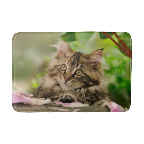 Cute Maine Coon kitten in a garden portrait photo Bath Mat