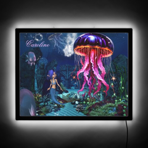 Cute mermaid looks at the beautiful jellyfish LED sign