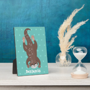 Cute otter diving on teal cartoon illustration plaque