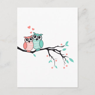 Cute owls in love on tree branch postcard