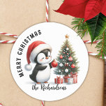 Cute Penguin Modern Personalized Merry Christmas Classic Round Sticker<br><div class="desc">Create stylish personalized white and red Christmas stickers for mailing seals,  favors or gift wraps with a design that says "Merry Christmas" and features a cute penguin in a red Santa hat decorating a Christmas tree. The template makes it easy to type your family name.</div>