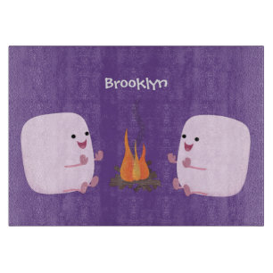 Cute pink marshmallows by camp fire cartoon cutting board