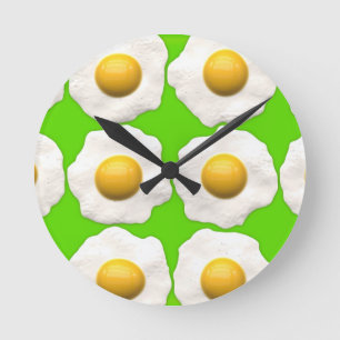 Cute pop art eggs on lime green background round clock