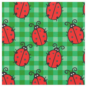 Cute red ladybug on green plaid cage fabric