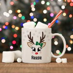 Cute Reindeer Girl Green Bow Custom Name Christmas Coffee Mug<br><div class="desc">Cute and girly Christmas coffee or hot cocoa mug features an illustration of a sweet Rudolph reindeer girl face with a shiny red nose, eyelashes, and antlers. She is dressed up with a green bow and surrounded by light gray snowflakes. Personalize this festive hot chocolate mug with a first name...</div>