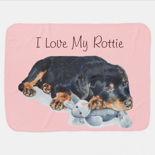 cute rottweiler puppy cuddling gray teddy bear dog receiving blanket