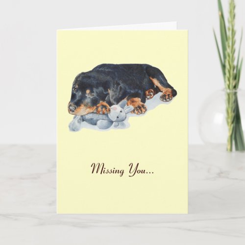 cute rottweiler puppy cuddling teddy missing you card