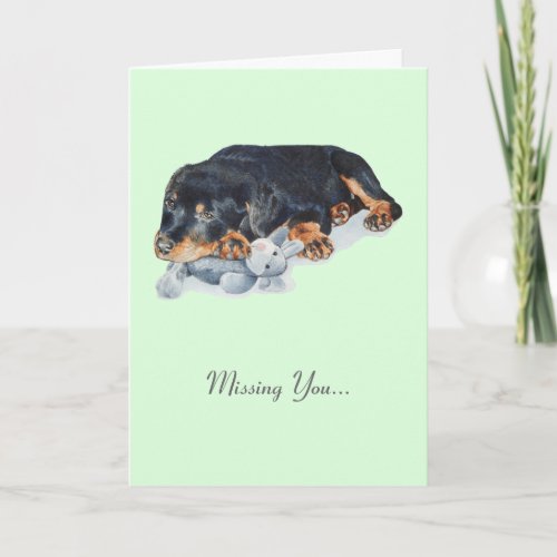 cute rottweiler puppy dog cuddling teddy bear art card