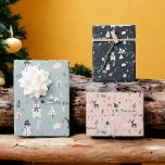 Cute scandi winter Christmas pattern illustration Wrapping Paper Sheets<br><div class="desc">Modern Cute scandi winter Christmas pattern illustration with blue,  orange colors featuring pine trees,  stars,  snowman,  cute bear,  deer,  mountains and cute other illustrations on ice blue,  navy blue and light pink editable background</div>