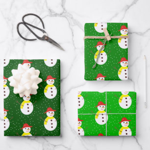 Cute snowman and snow on green wrapping paper sheets