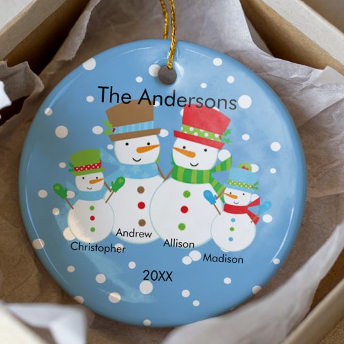 A dated gingerbread family ornament on a Christmas tree