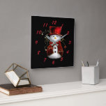 Cute Snowman in Red Velvet Christmas Square Wall Clock<br><div class="desc">A cute Christmas pattern of a snowman in a red velvet hat and jacket,  with gold stars around him,  repeated across a black background to add a touch of cuteness and holiday cheer to your gifts this Christmas season.</div>